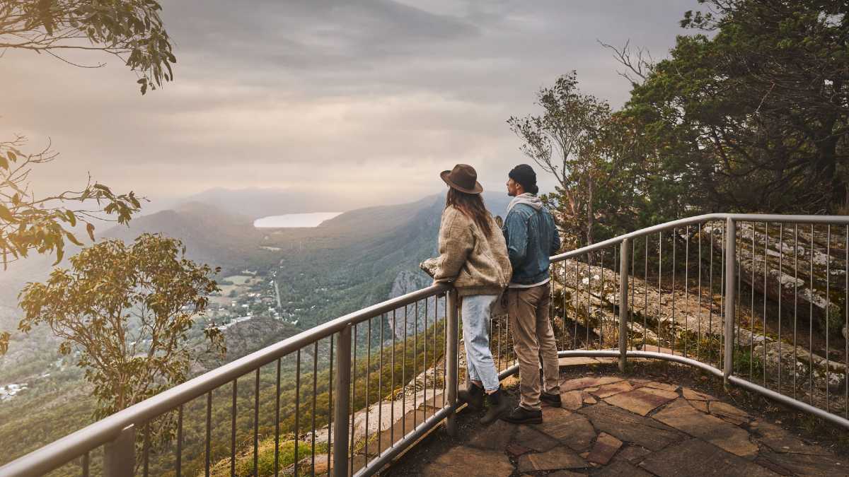 couple standing at mountain lookout