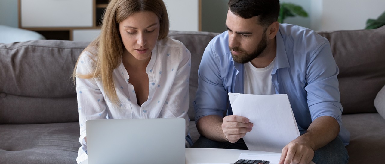 Couple on laptop making serious financial decisions