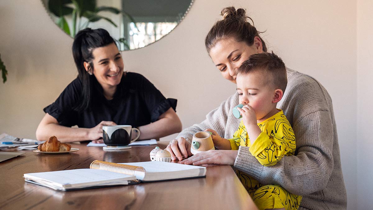 Female couple with toddler at family table