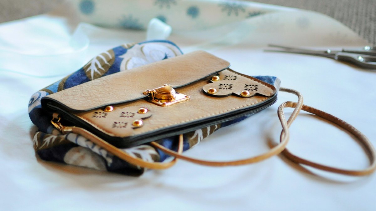 A stylish, designer handbag with gold accents