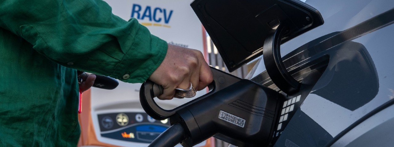 woman charging her electric vehicle at a Chargefox charger