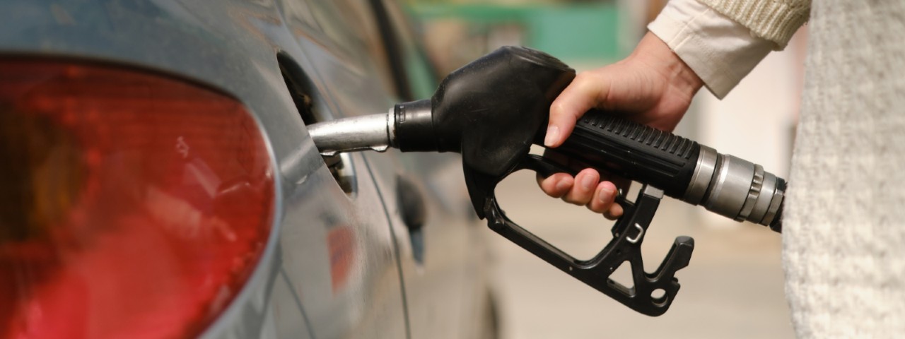 close up of person fuelling their car from a bowser
