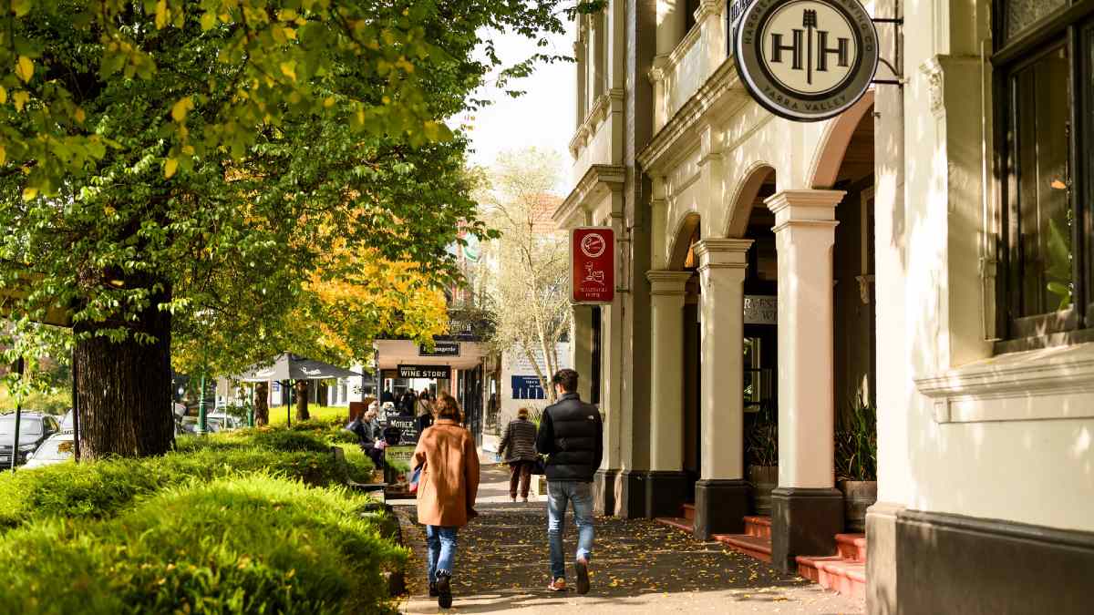 people walking down an autumn street in Healesville