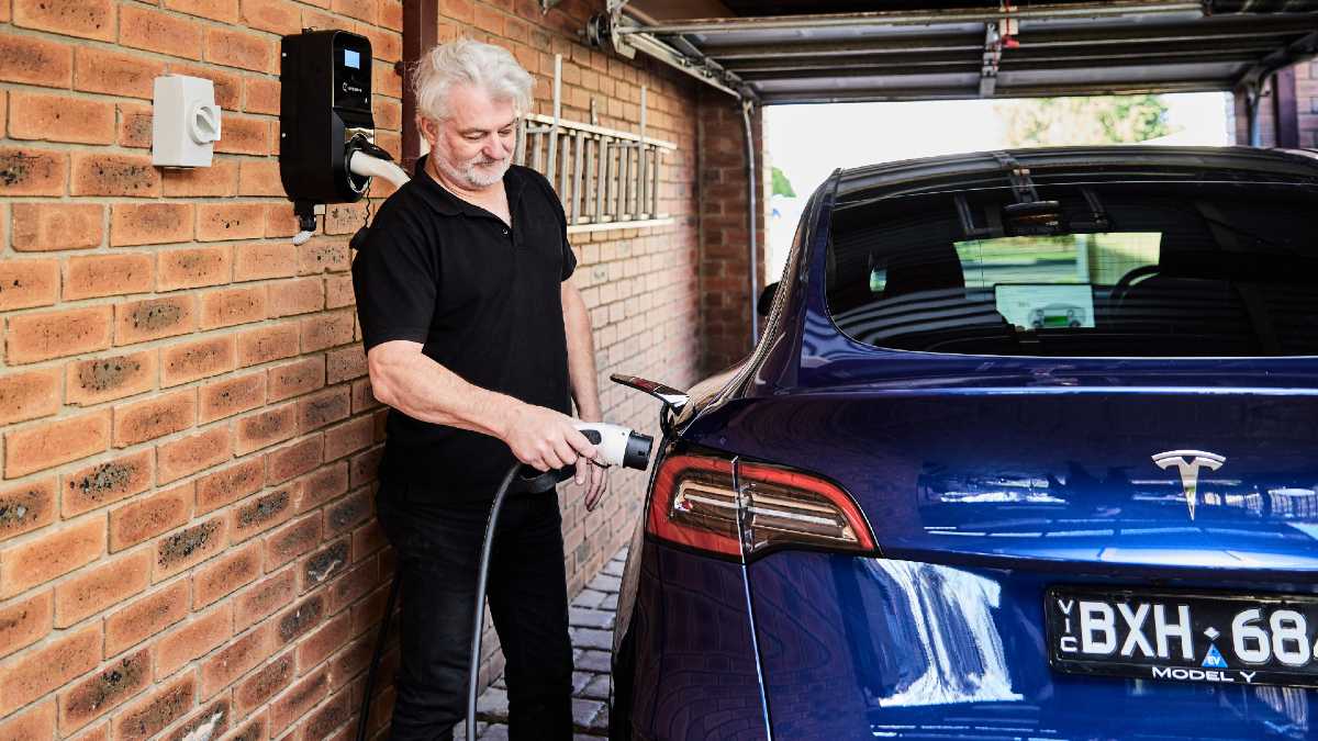 man charging his Tesla EV at home using JET Charge