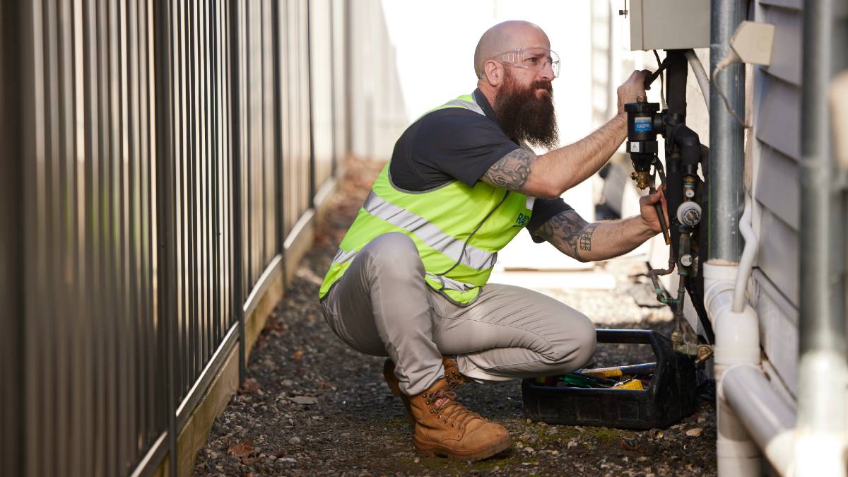man checking temperature of shower