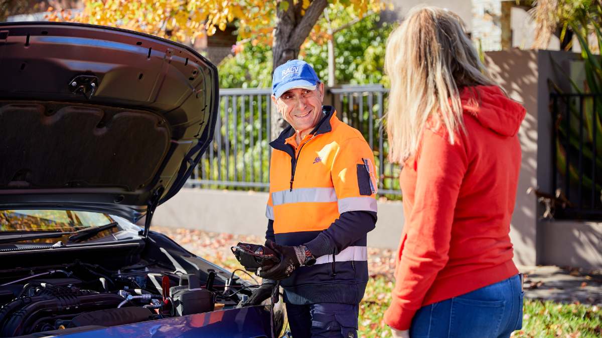 RACV ERA worker in hi-vis safety vest checking battery life in customer's car