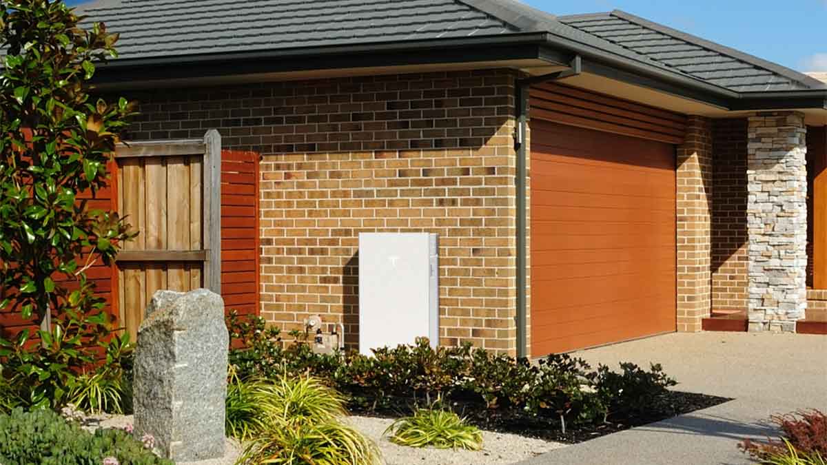 Tesla Powerwall 3 attached to side of brick house