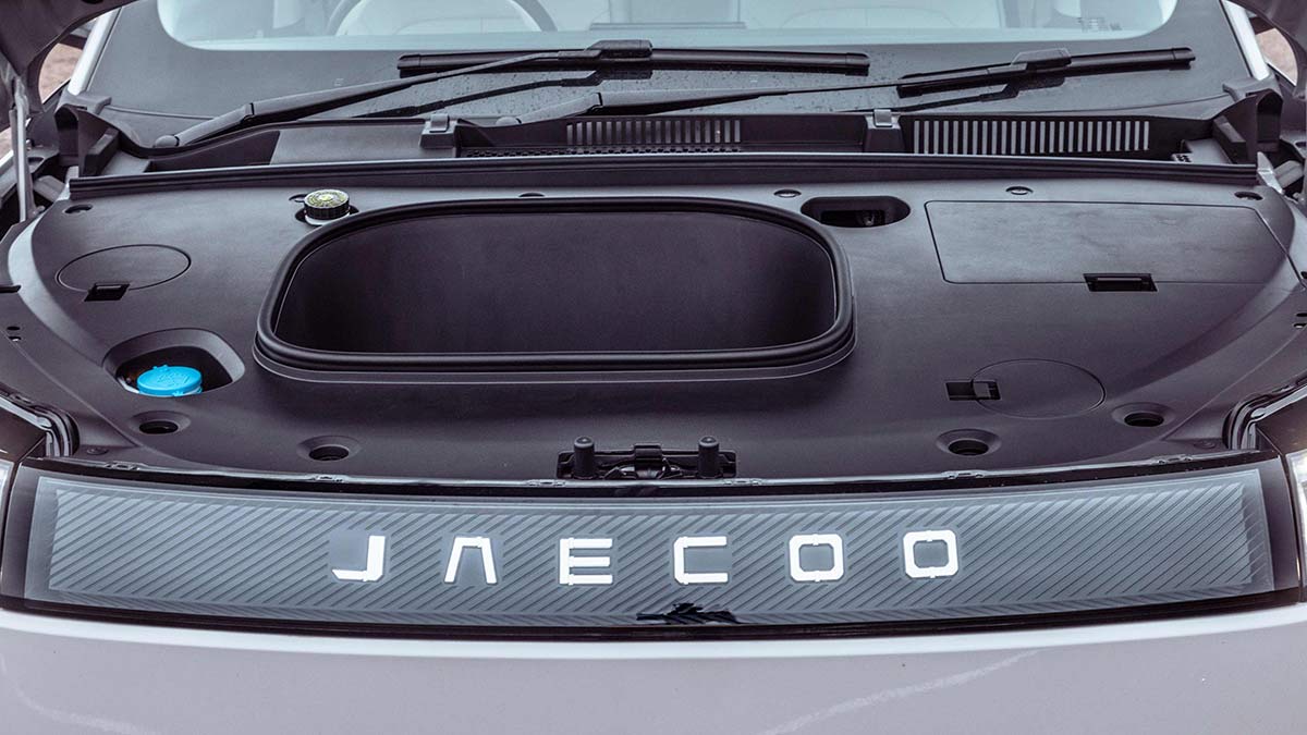Bonnet of white Jaecoo J5 electric SUV open showing front storage binnacle.