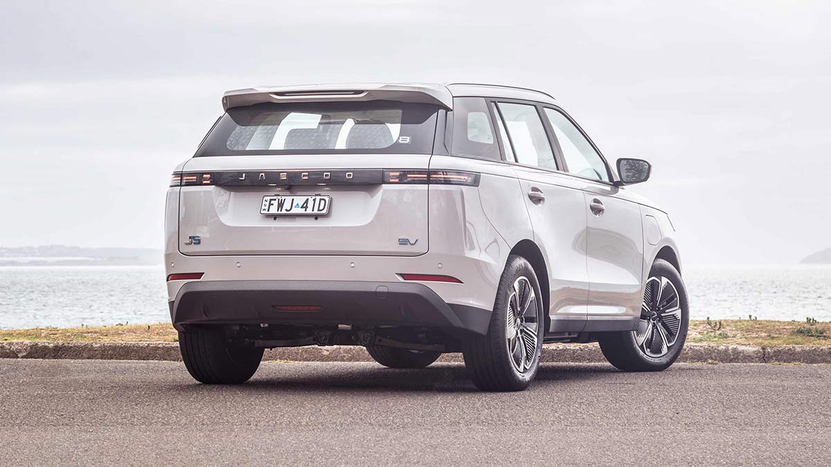 Rear view of Jaecoo J5 EV small SUV at beachfront carpark.