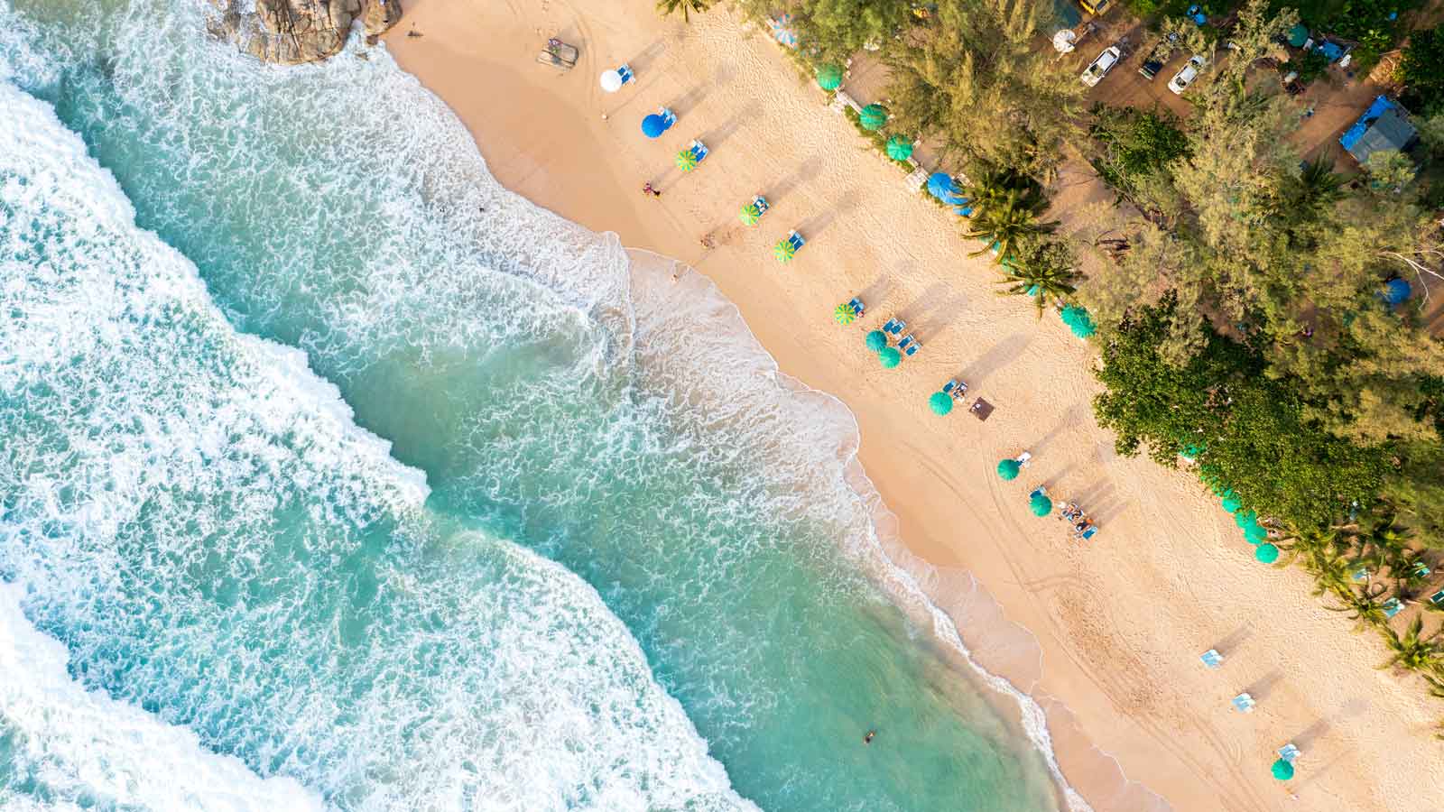 Aerial drone top view crowd of happy people relaxing at tropical beach in Phuket, Thailand