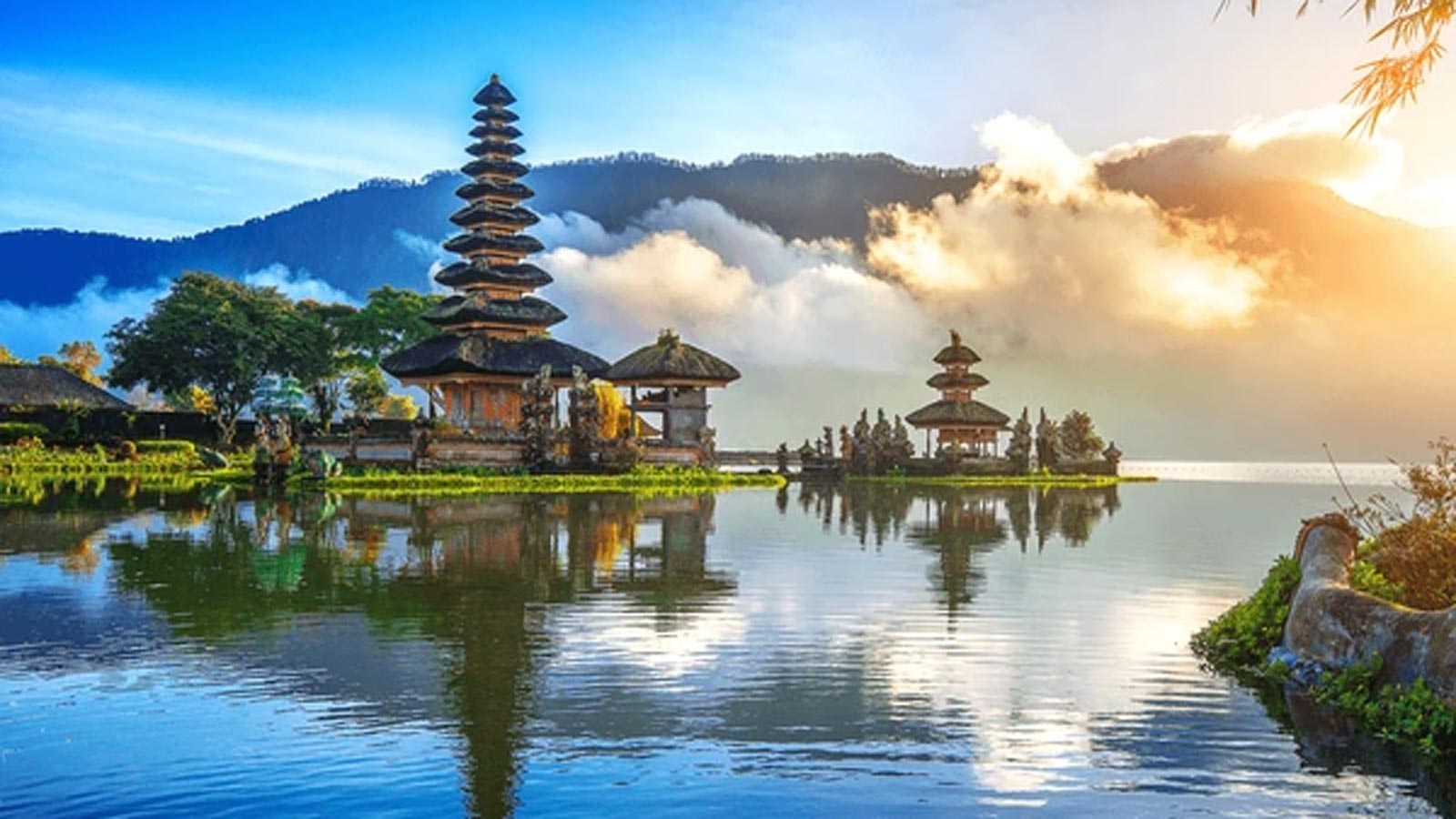 Traditional Balinese temple surrounded by water by the mountains.