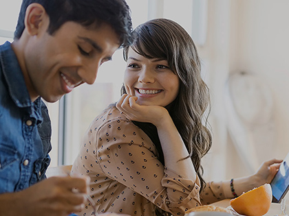 Couple smile at the opportunity to buy a new house