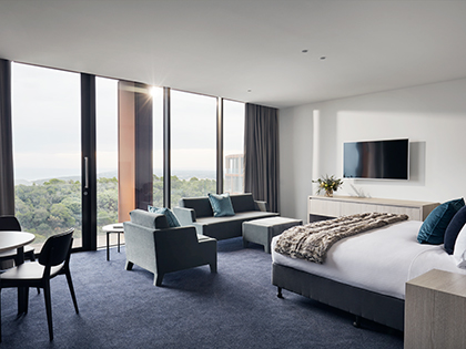 Family room at RACV Cape Schanck Resort, featuring a bed, couches and table and chairs.