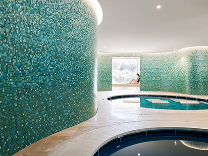 Woman sitting up against window in hammam bathing room at RACV Cape Schanck Resort's One Spa.
