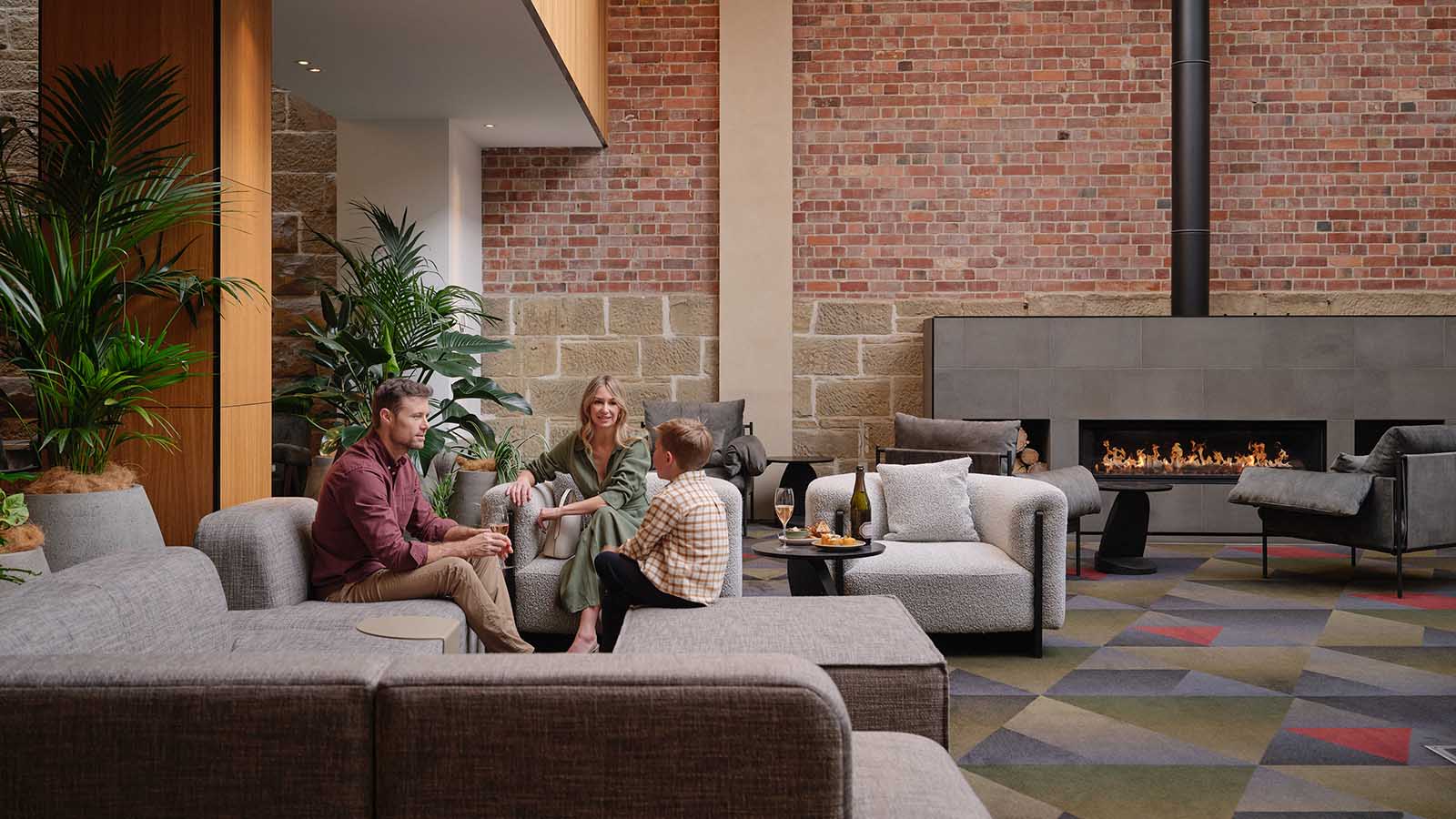 A family chatting on the lounge at RACV Hobart Hotel.
