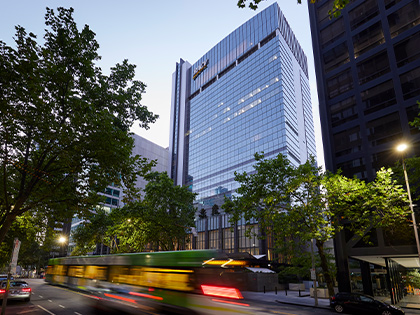 Exterior shot of the RACV City Club with a tram passing.