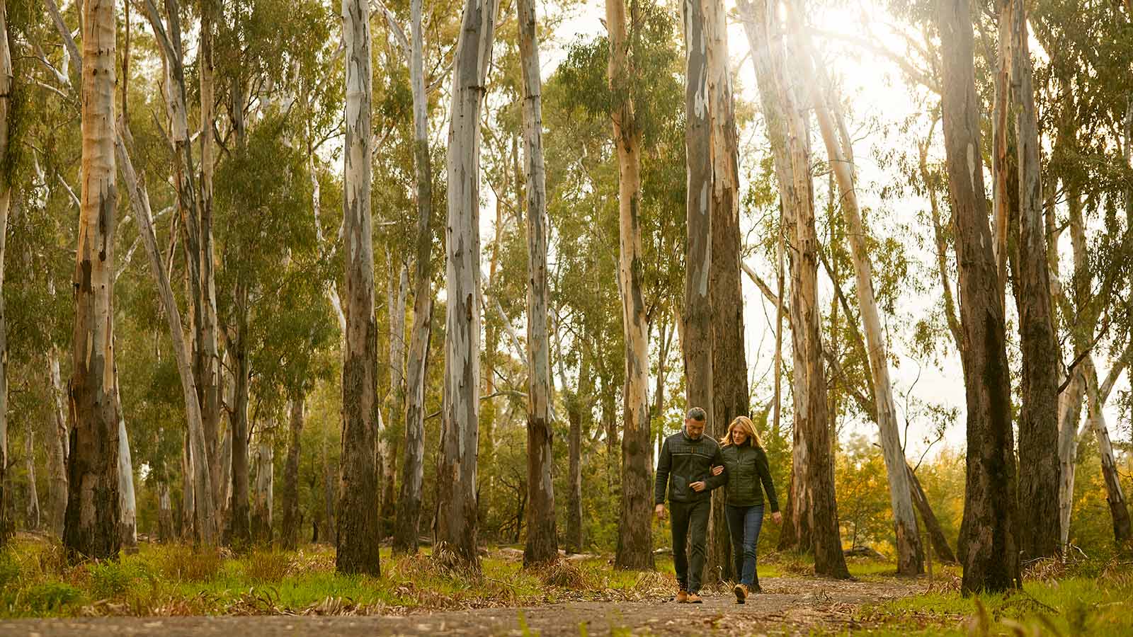 Two people walking in bushland in Cobram.
