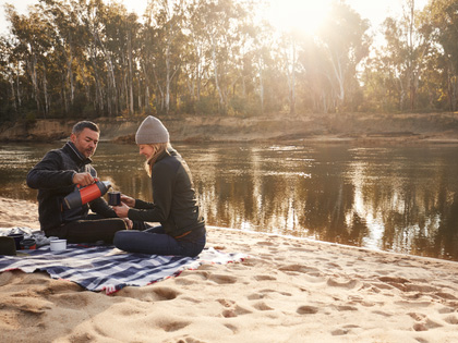 A couple enjoying a picnic on the Murray RIver. 