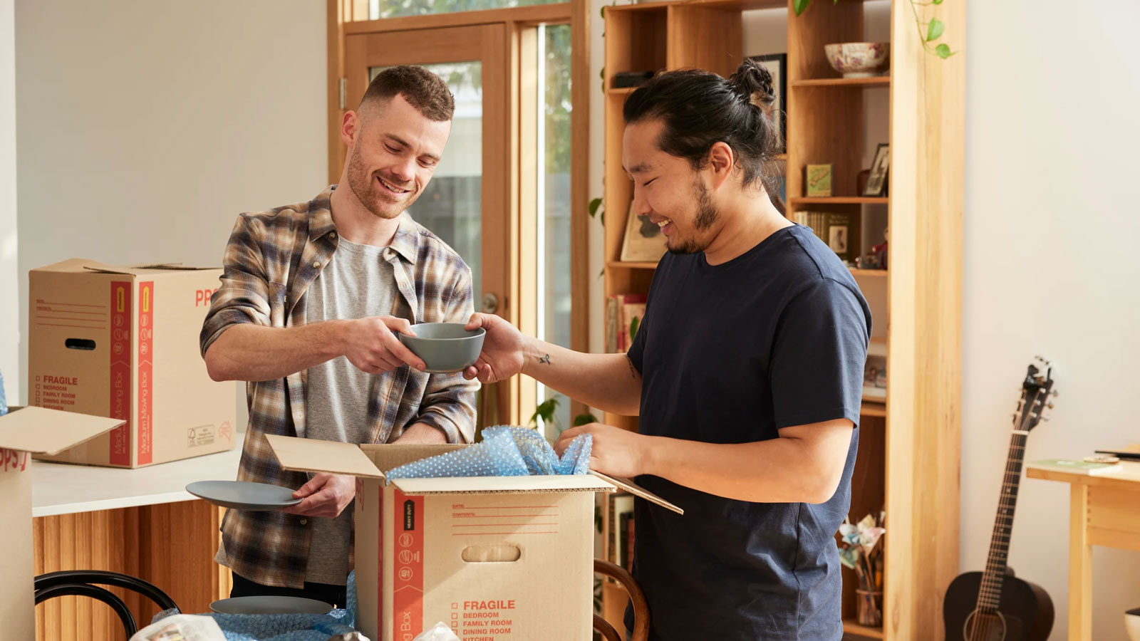 Couple unpacking boxes as they set up their new home