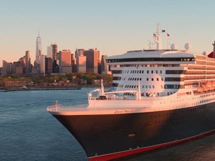 A large cruise ship infront of New York City. 