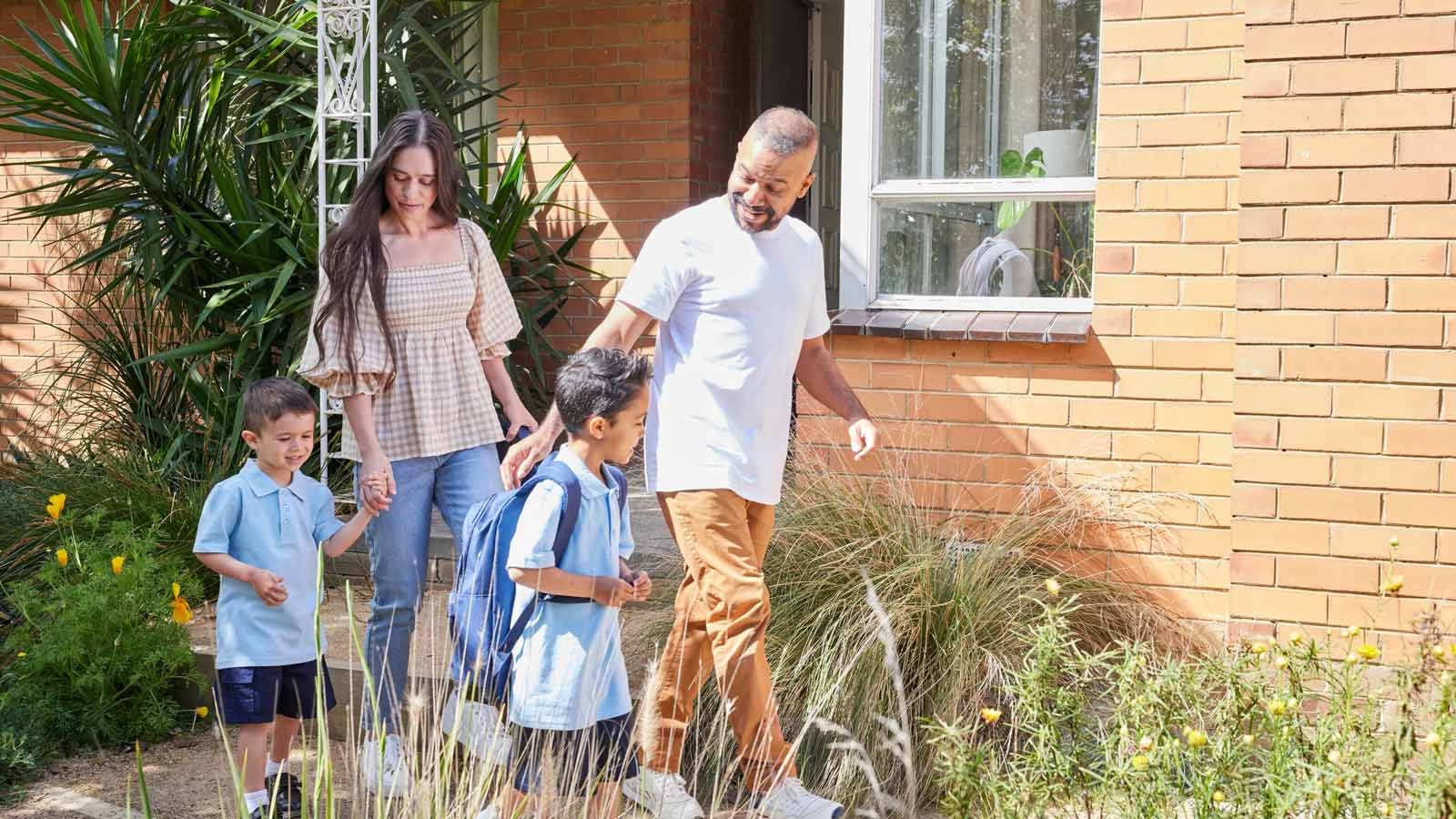 Mum and dad taking their two children to school