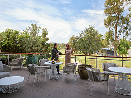 Two people talking at RACV Goldfields Resort's Springs Bar and Terrace.