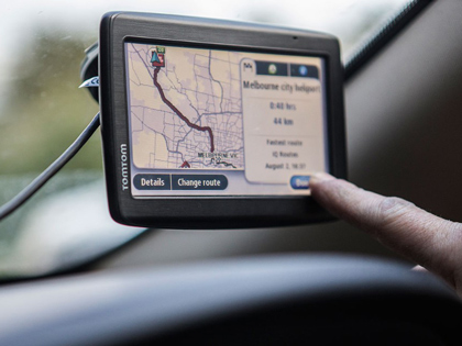 Dashboard with a person about to touch the GPS.