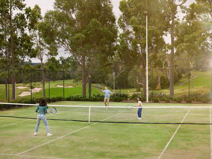 A family playing tennis at the Healesville Country Club.