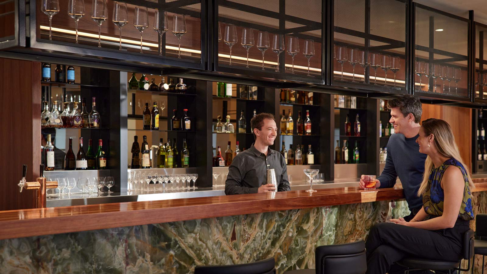 Bartender serving couple by Banyalla restaurant bar at RACV Healesville Country Club and Resort.