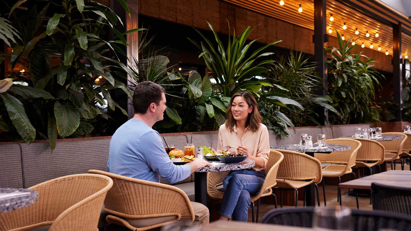 Two people sharing a meal at Riddell's Green restaurant at RACV Healesville Country Club and Resort.