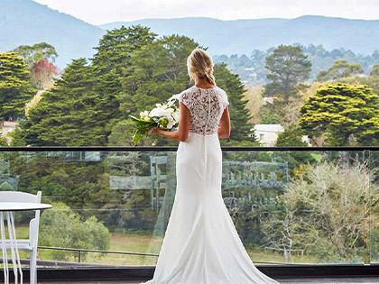 Bride overlooking a balcony at the Healesville Country Club and Resort.