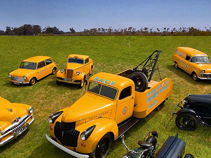 RACV fleet of various roadside assistance vehicles parked on a field.