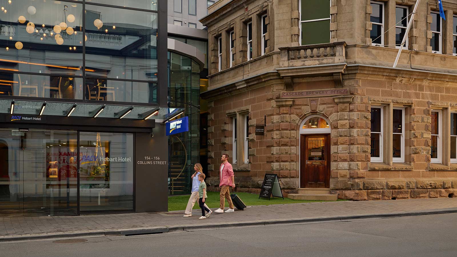 A wide shot of a family arriving at the RACV Hobart Hotel.