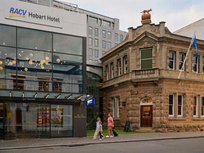 A wide shot of a family arriving at the RACV Hobart Hotel.