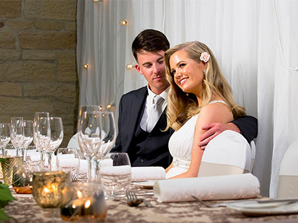 Bride and groom smiling at each other and posing.