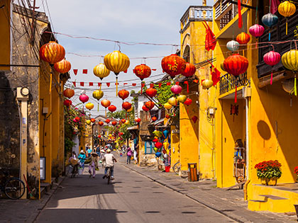 Yellow buildings with red lanterns on the streets of Hoi An.