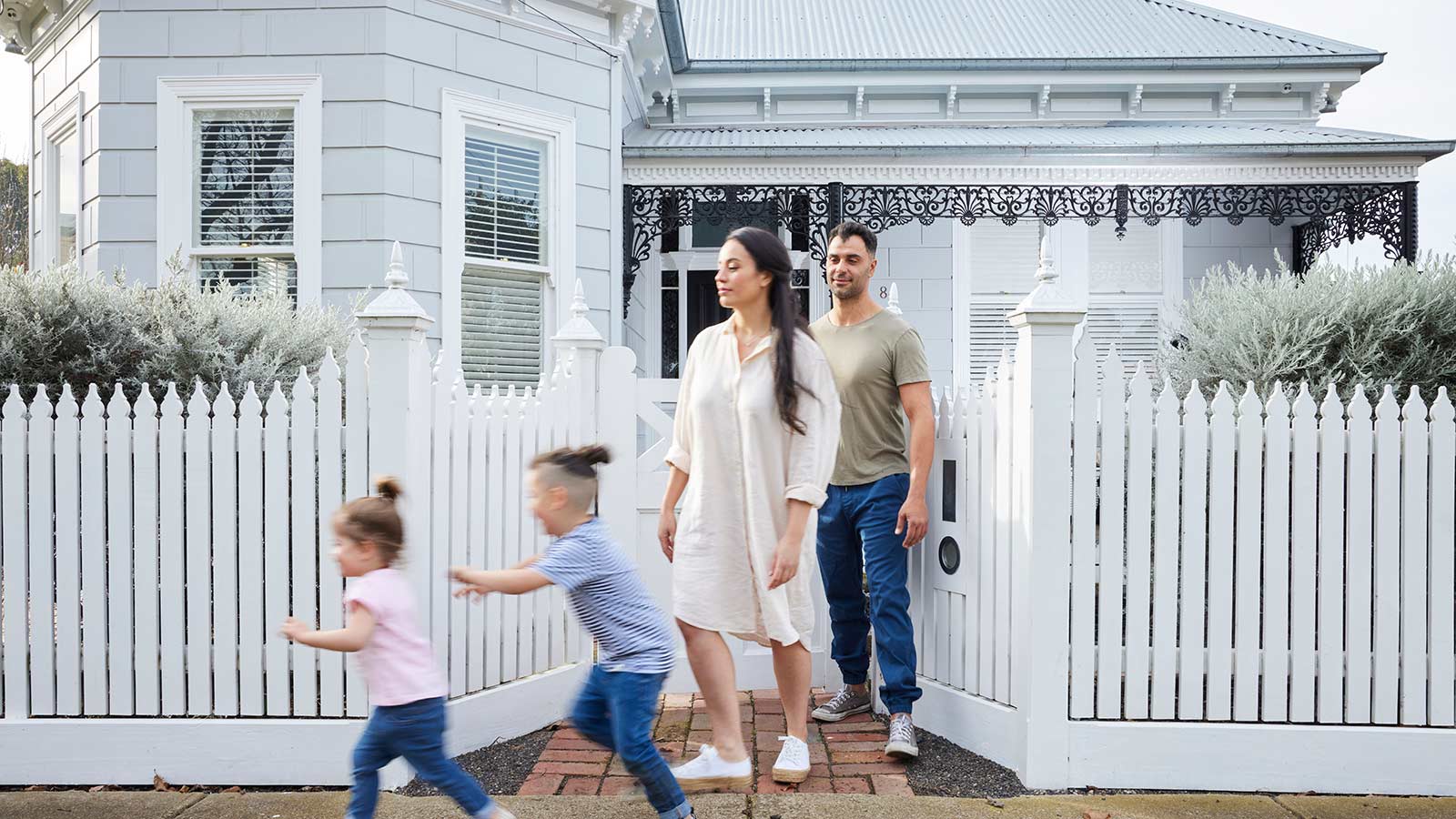 Young family outside the front of their home