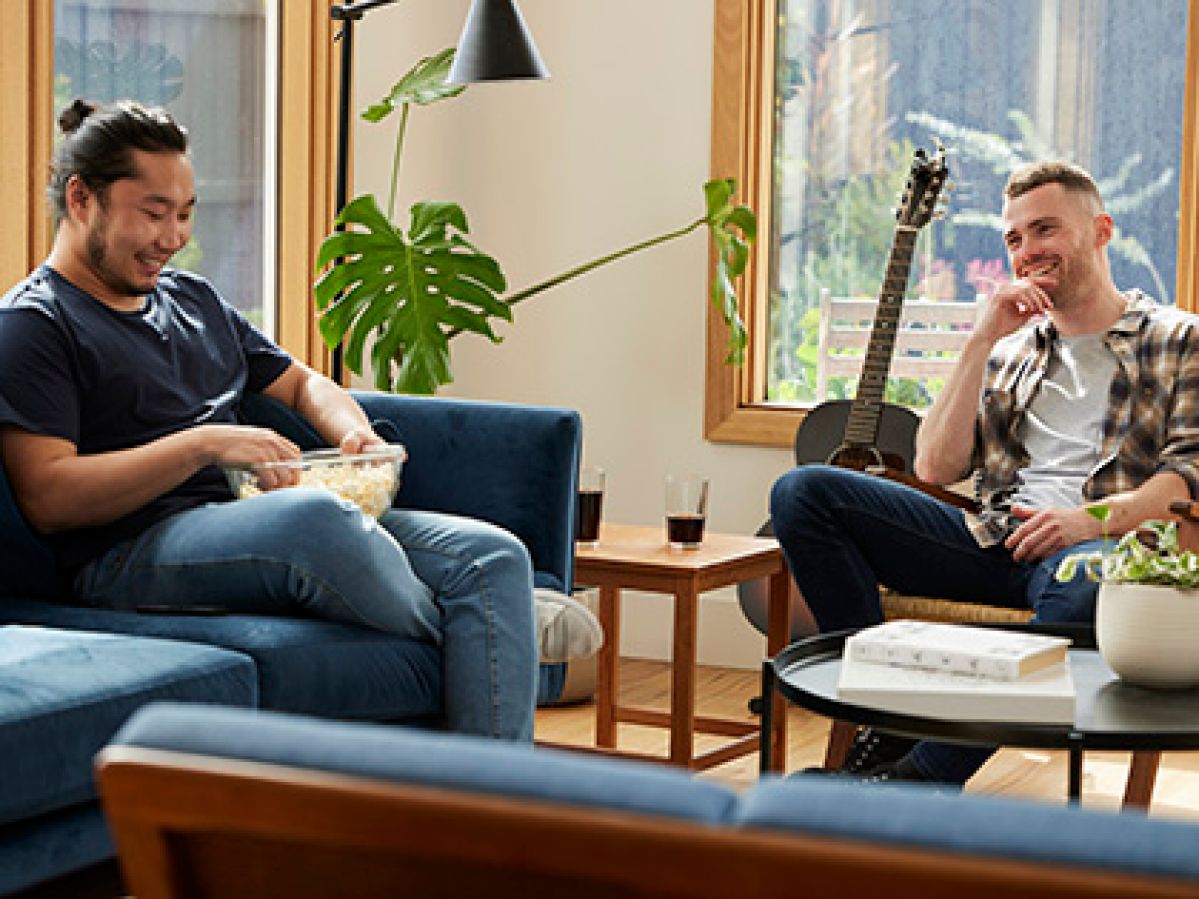 Two renters relaxing in their loungeroom.