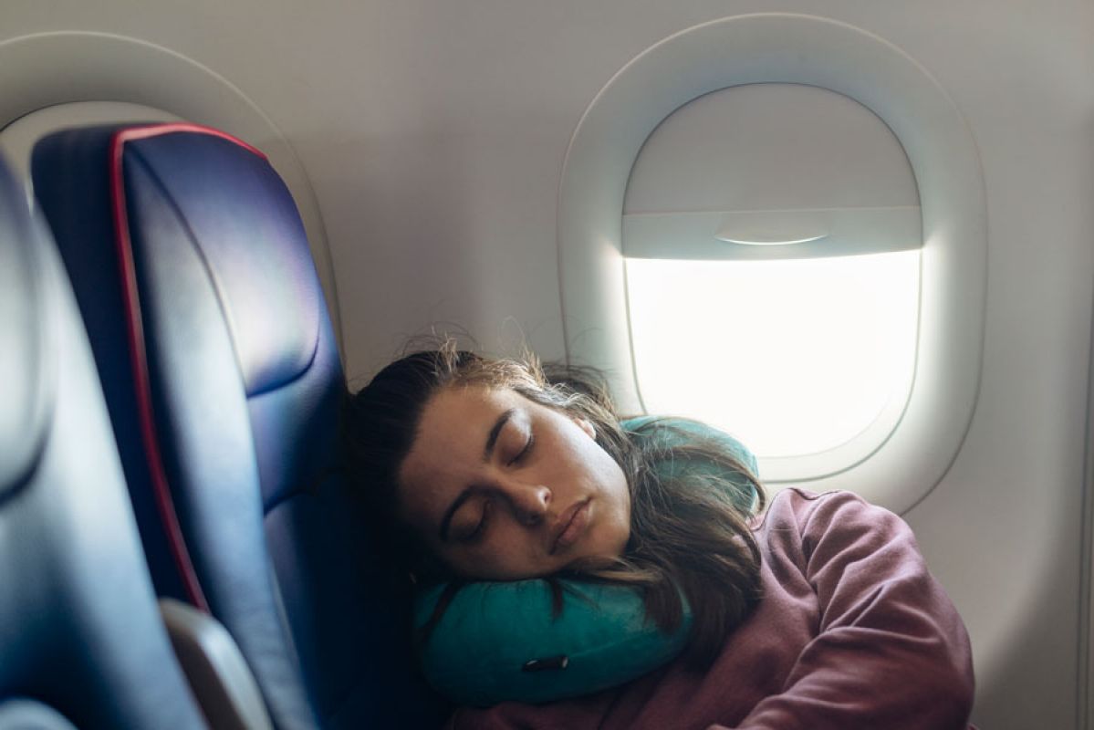 woman sleeping on plane