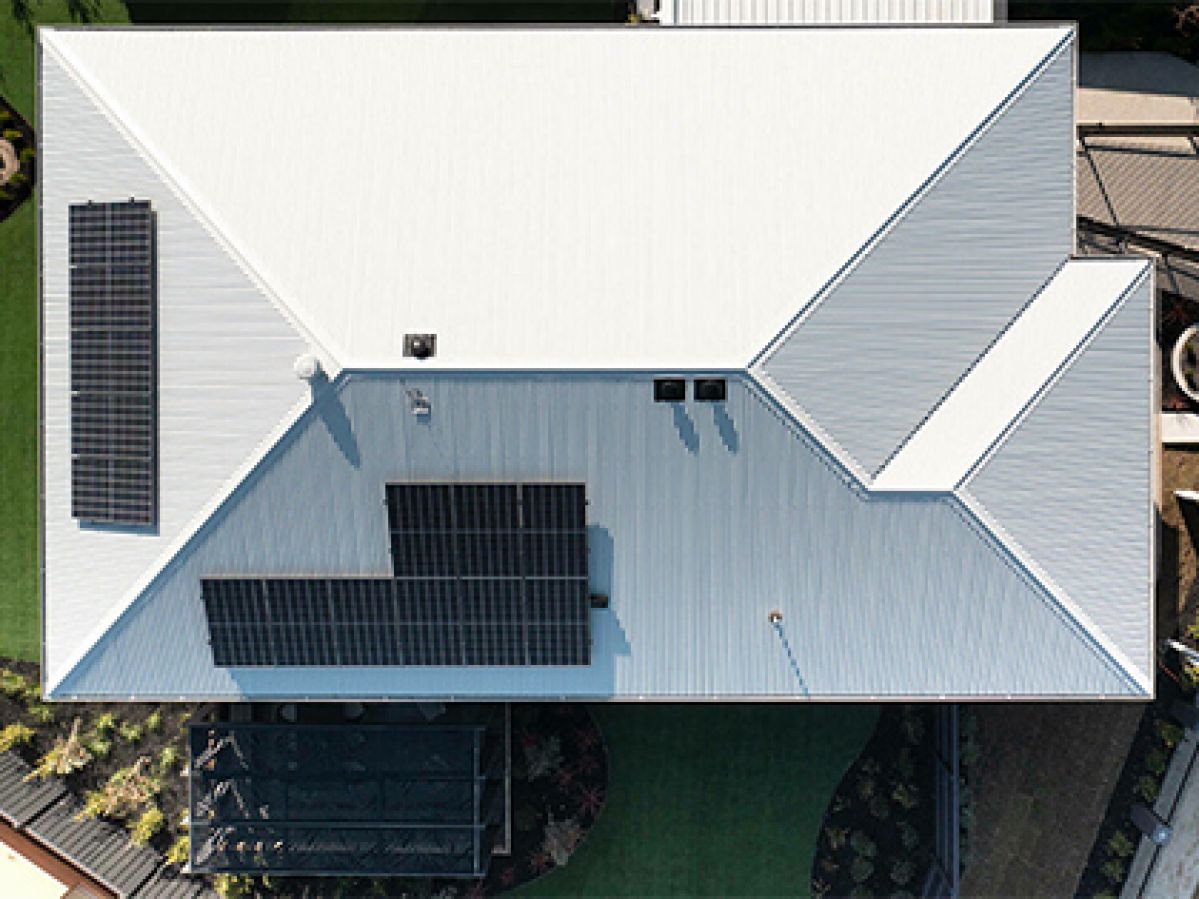 Aerial view of a house with solar panels.