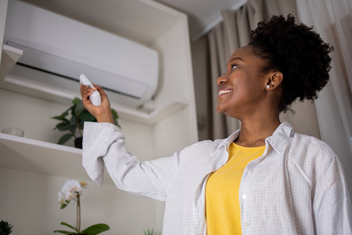 woman in front of air conditioner