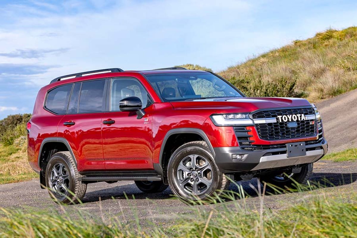 Red Toyota LandCruiser Hybrid at bottom of steep incline at proving ground in Altona.