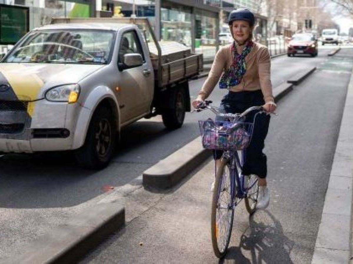 Woman rides bike to work.