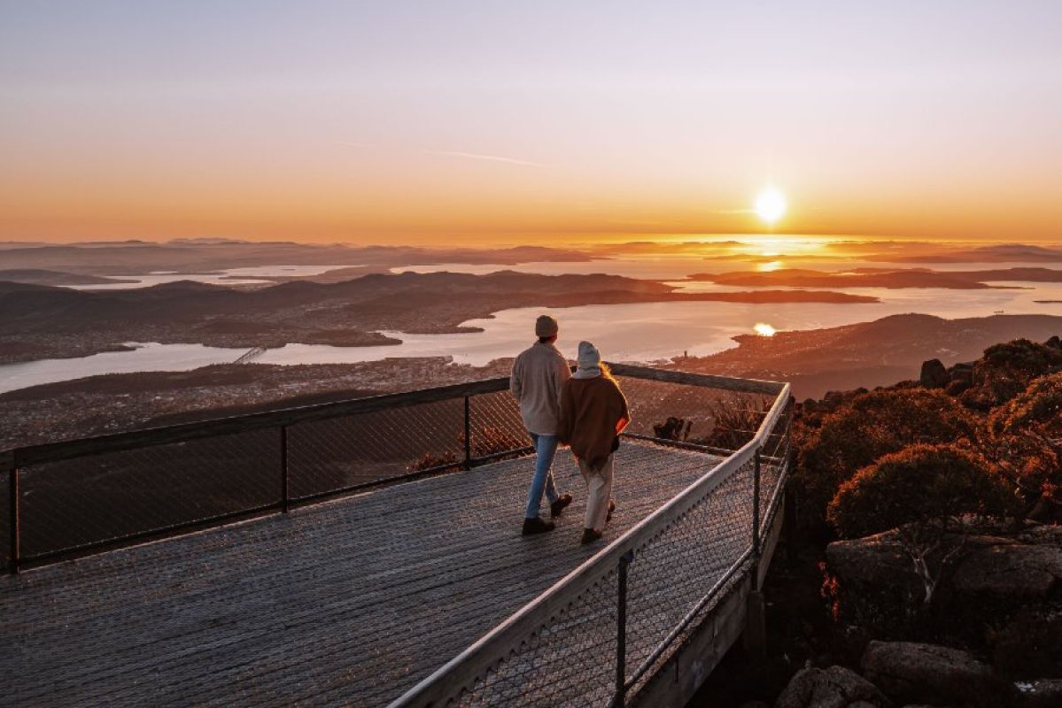 couple at Mt Wellington looking out over Hobart at sunset