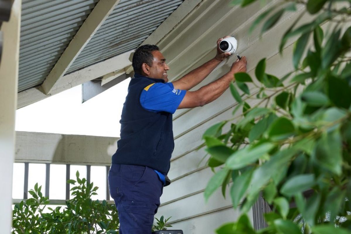 RACV technician installing a CCTV camera