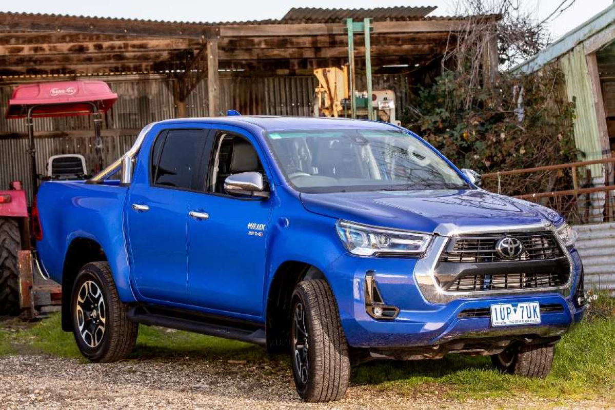 A 2022 Toyota Hilux abandoned by a farm building