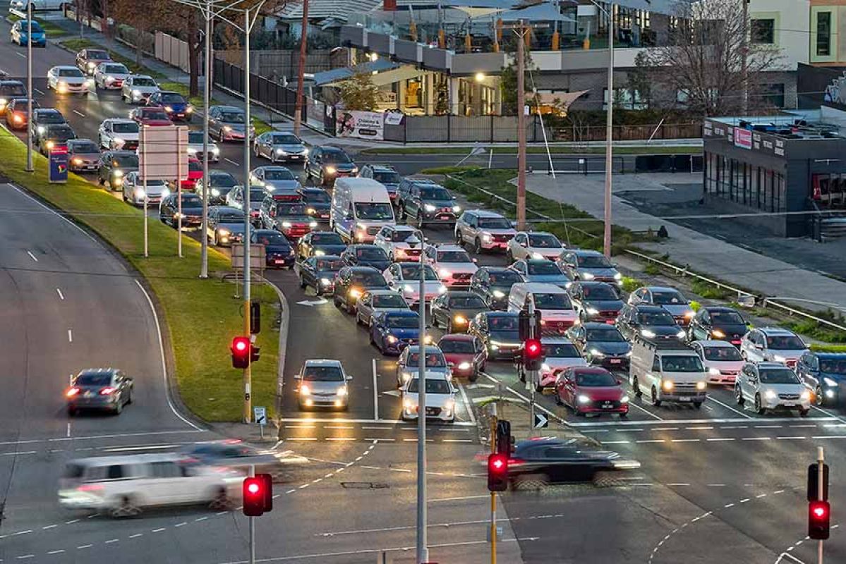 Long line of traffic stopped at red light at intersection