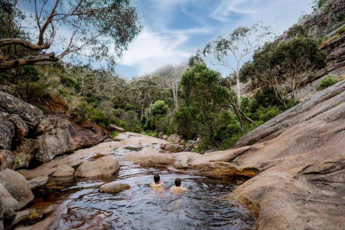 Two people relaxing in the Venus Baths near Halls Gap