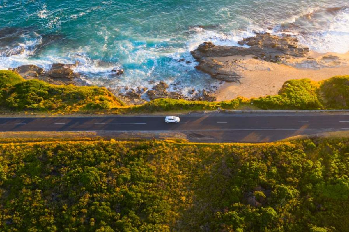 car driving along coastal road