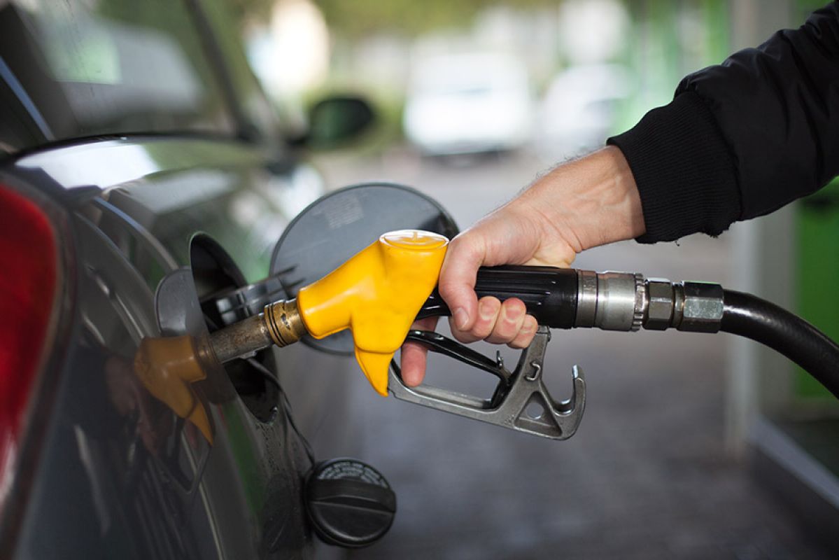 person pumping fuel into car